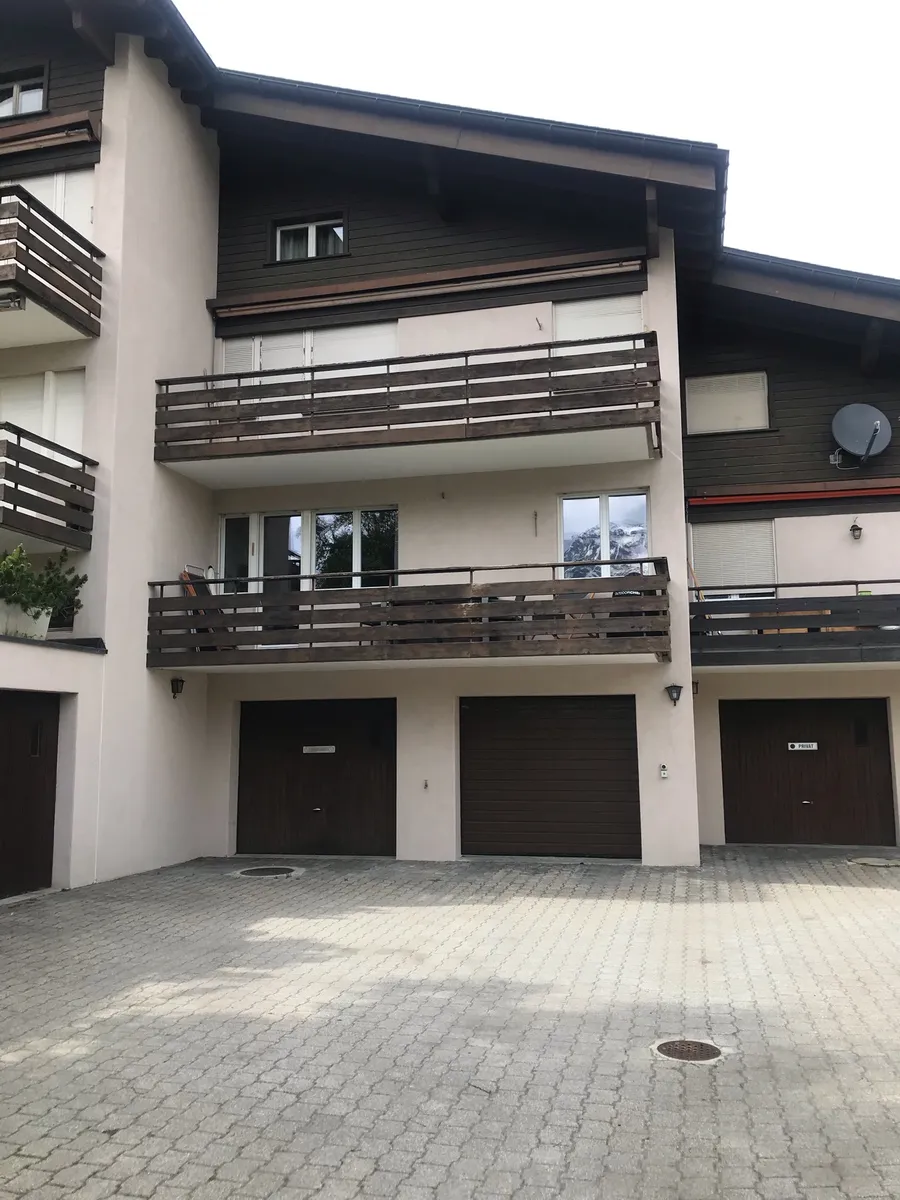 Hausfassade mit Balkonen und Garagen